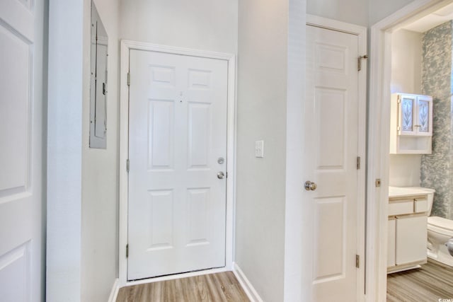 entryway with light wood-style floors and baseboards