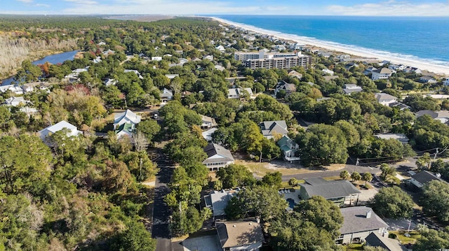 drone / aerial view with a water view and a beach view