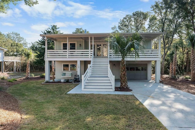 view of front of house with a front lawn, stairway, concrete driveway, covered porch, and an attached garage