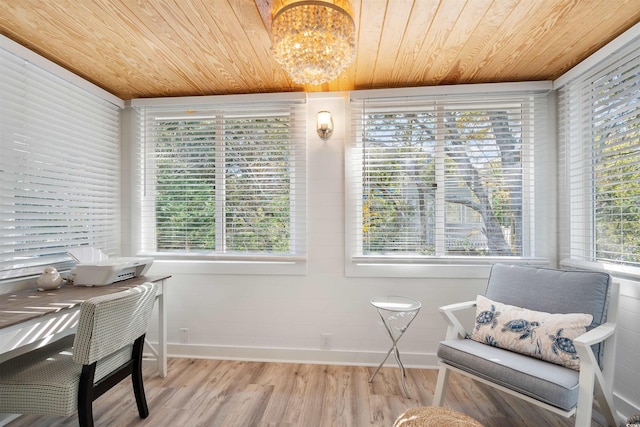 interior space with a notable chandelier, a healthy amount of sunlight, wooden ceiling, and light wood-type flooring