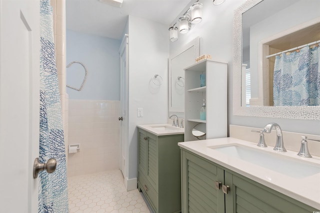 bathroom featuring tile patterned flooring, two vanities, a shower with curtain, and a sink