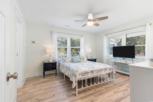 bedroom with a ceiling fan, light wood-style flooring, baseboards, and visible vents