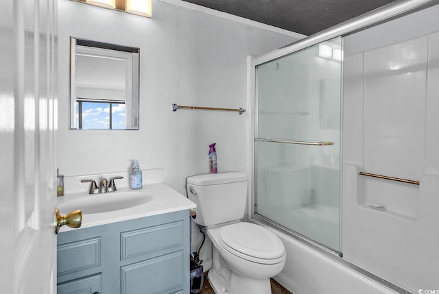 bathroom with toilet, vanity, and shower / bath combination with glass door