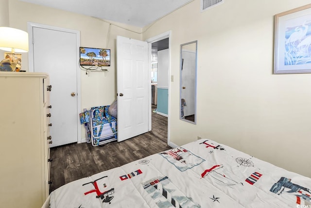 bedroom with visible vents and wood finished floors