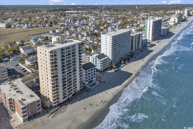 birds eye view of property featuring a water view, a city view, and a beach view