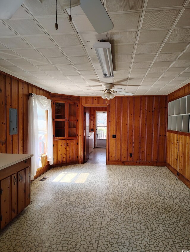 1375 Kenny Jordan Rd, Tabor City, NC 28463 - unfurnished room featuring visible vents, electric panel, wooden walls, light floors, and washer / dryer