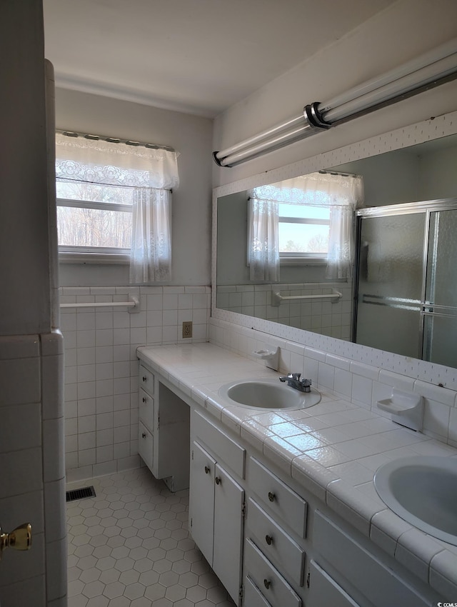 1375 Kenny Jordan Rd, Tabor City, NC 28463 - full bath featuring visible vents, a sink, tile walls, tile patterned flooring, and double vanity