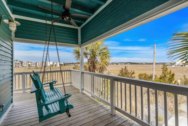 wooden deck featuring ceiling fan