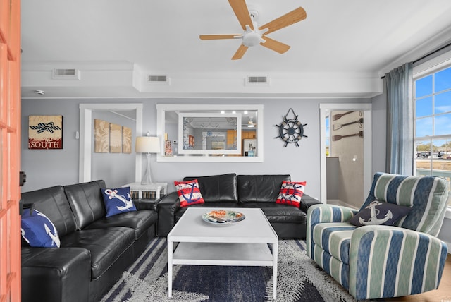 living room featuring visible vents and ceiling fan