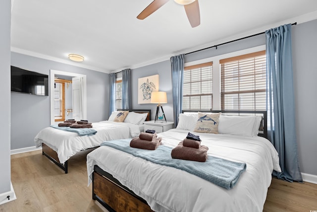 bedroom with ceiling fan, baseboards, wood finished floors, and ornamental molding