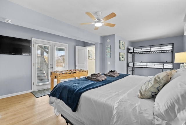 bedroom featuring baseboards, a ceiling fan, light wood-style floors, and access to outside