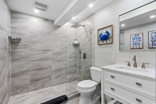 bathroom featuring visible vents, toilet, recessed lighting, walk in shower, and vanity