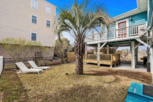 view of yard with a patio, a deck, and fence