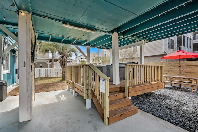 wooden deck featuring a patio area and fence