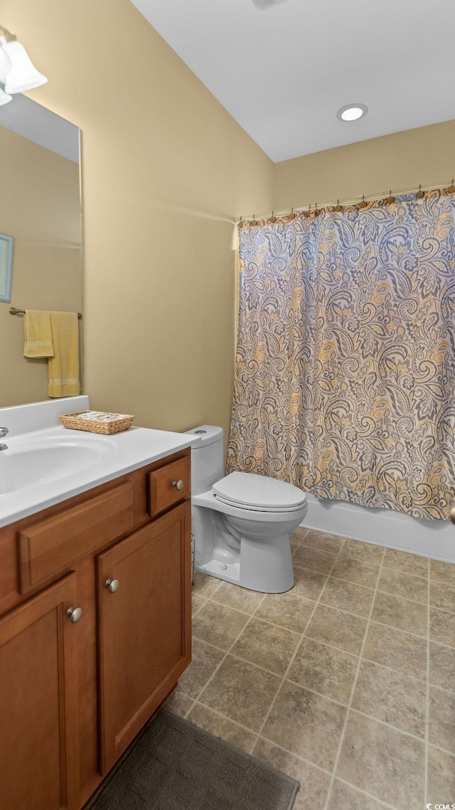 full bathroom with toilet, shower / bath combo, tile patterned flooring, vanity, and vaulted ceiling