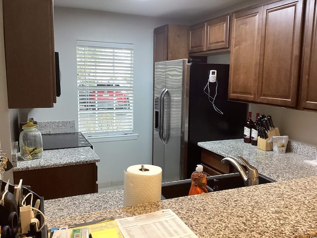 kitchen with stainless steel fridge and light countertops