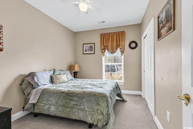 bedroom with carpet, visible vents, baseboards, ceiling fan, and a closet