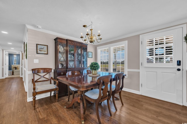 dining space with baseboards, a notable chandelier, wood finished floors, and ornamental molding