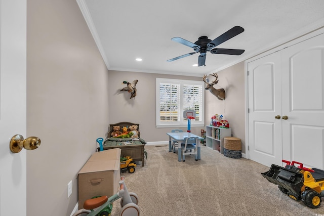 playroom featuring a ceiling fan, carpet, baseboards, recessed lighting, and ornamental molding