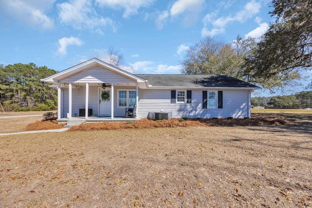 single story home with central AC unit, a ceiling fan, and covered porch