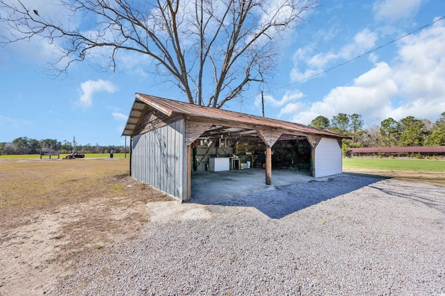 view of parking featuring an outbuilding and a garage