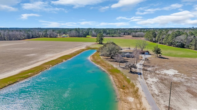 birds eye view of property with a water view and a beach view