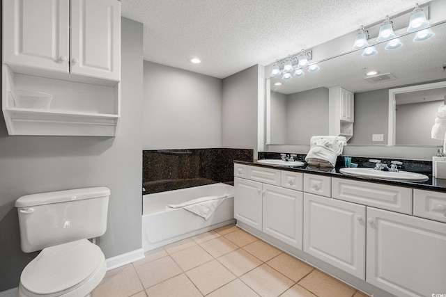 bathroom featuring tile patterned floors, a textured ceiling, toilet, and a sink