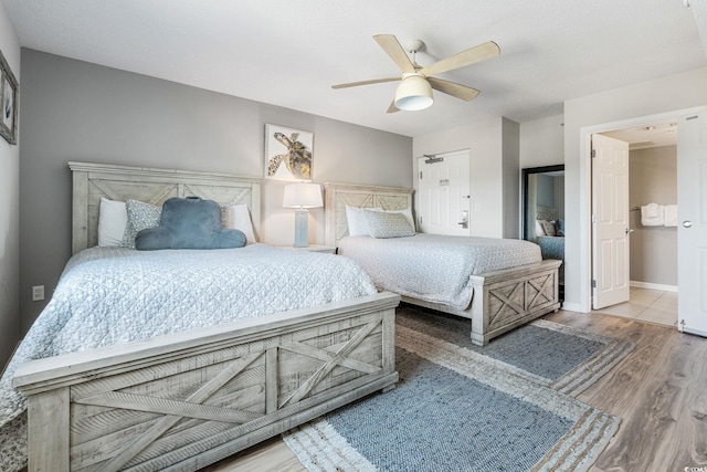 bedroom featuring wood finished floors, baseboards, and ceiling fan