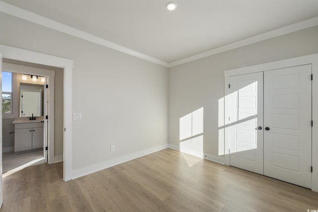 entrance foyer with wood finished floors, baseboards, and ornamental molding