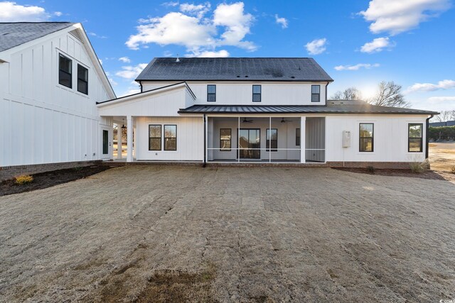 back of house featuring a ceiling fan, a sunroom, a standing seam roof, and metal roof