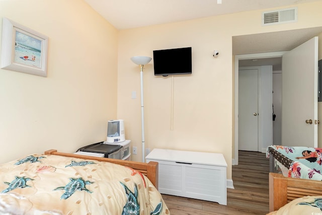 bedroom featuring wood finished floors and baseboards