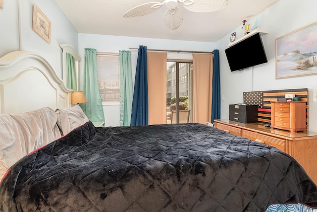 bedroom with access to exterior and a ceiling fan