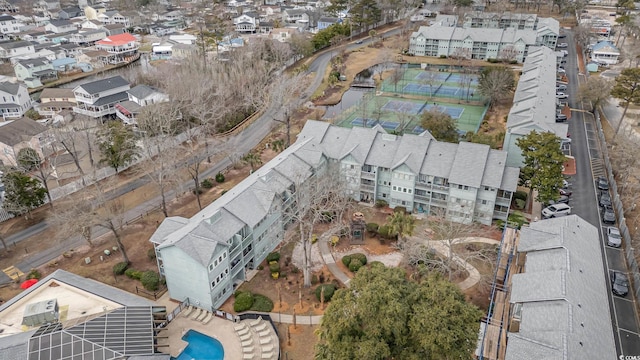 aerial overview of property's location with a pool and nearby suburban area