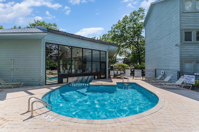 community pool featuring a patio and fence