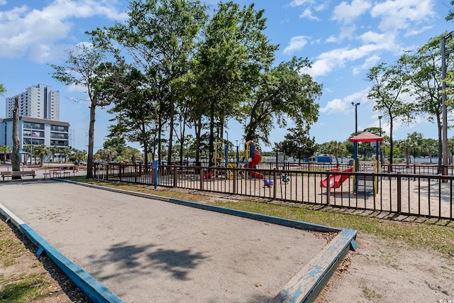 community play area with fence and a bocce ball area