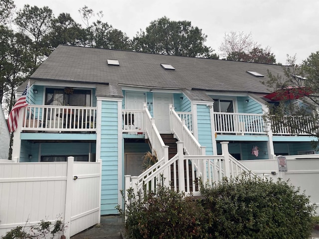 view of front of house with stairs and fence