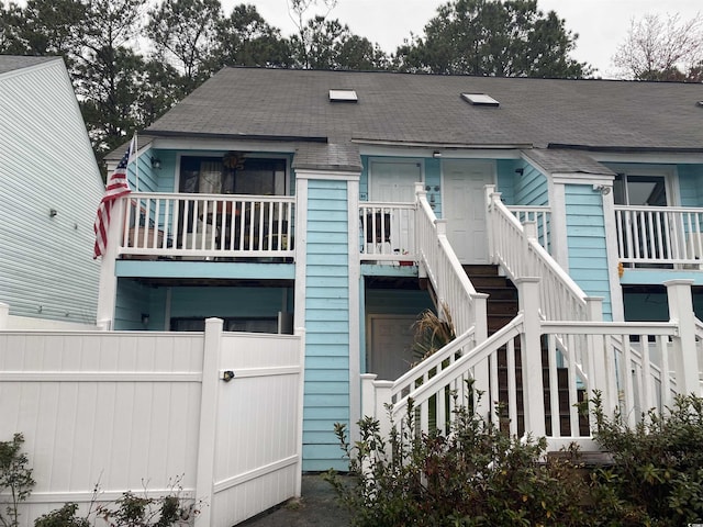 view of front of property with stairs and fence