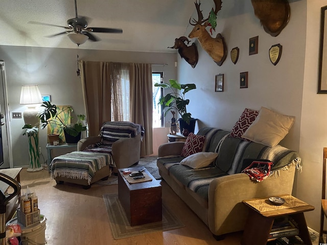 living room featuring ceiling fan and wood finished floors