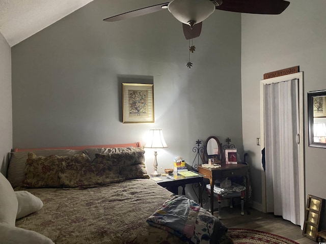 bedroom featuring lofted ceiling, wood finished floors, and ceiling fan