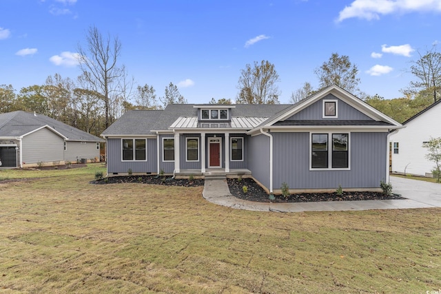 view of front of house featuring a standing seam roof, metal roof, and a front yard