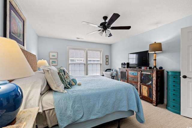 bedroom featuring carpet flooring, a ceiling fan, and visible vents