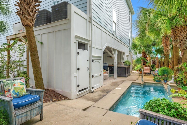 view of swimming pool featuring a fenced in pool, central AC, and a patio