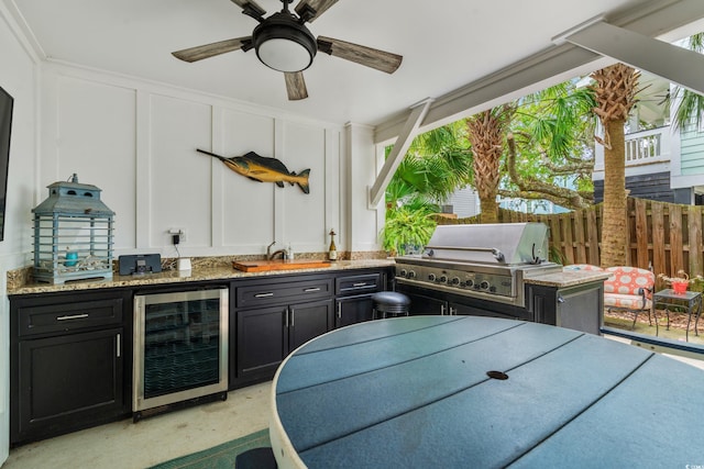 view of patio / terrace featuring outdoor dining space, a ceiling fan, beverage cooler, fence, and grilling area