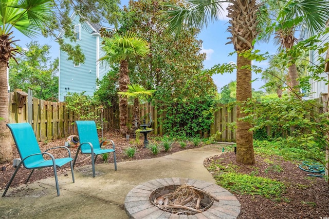 view of patio with a fenced backyard and an outdoor fire pit