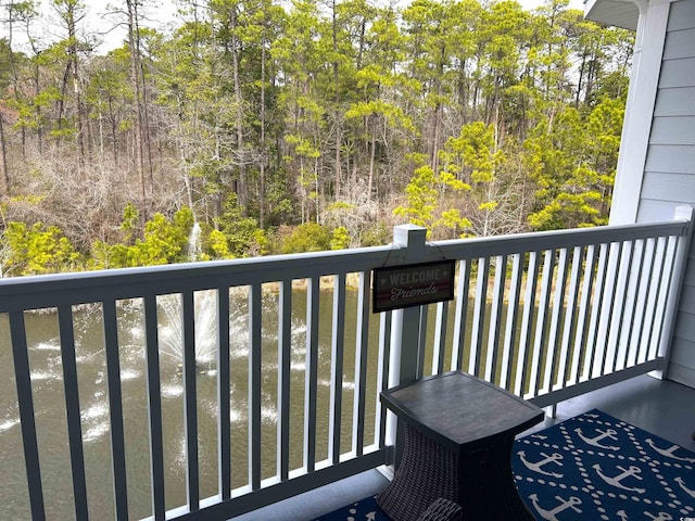 balcony featuring a forest view