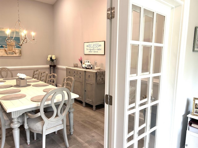 dining space featuring a notable chandelier and light wood-style floors