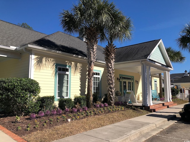 view of front of property with a porch and a shingled roof