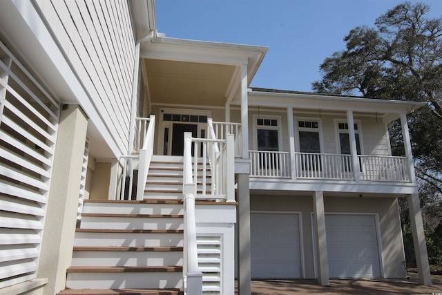 doorway to property with a garage and driveway