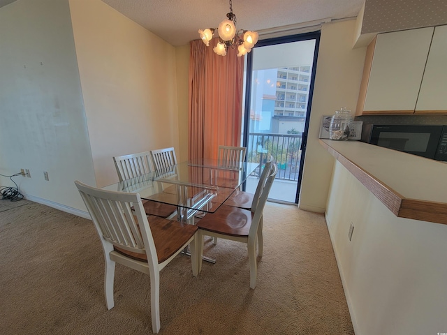 dining area with light carpet, baseboards, an inviting chandelier, and expansive windows