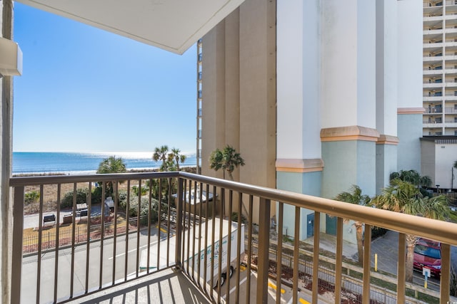 balcony featuring a beach view and a water view